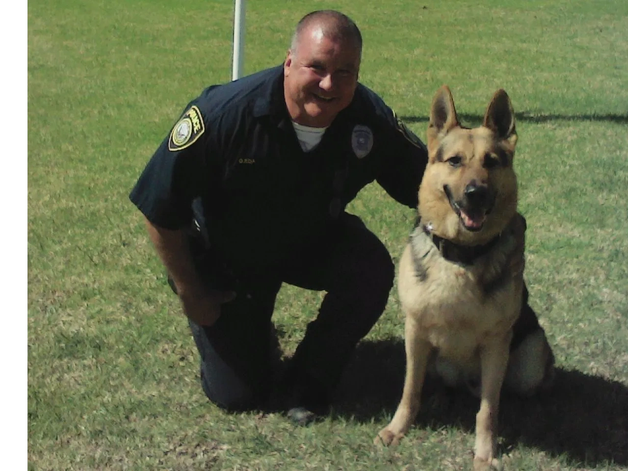 Retired Police Lieutenant Mark Ojeda with a German Shepherd